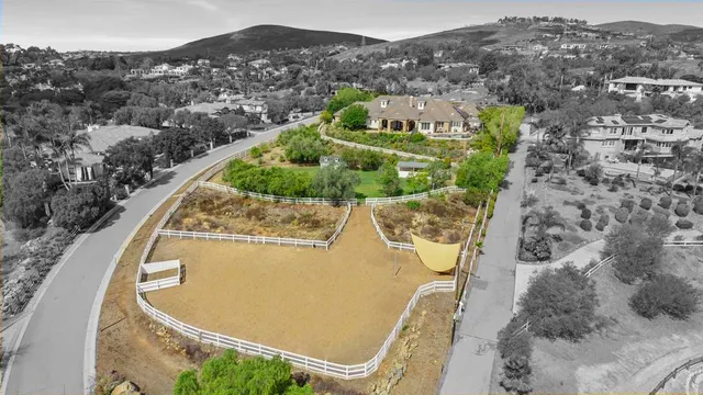 an aerial view of a house with a swimming pool