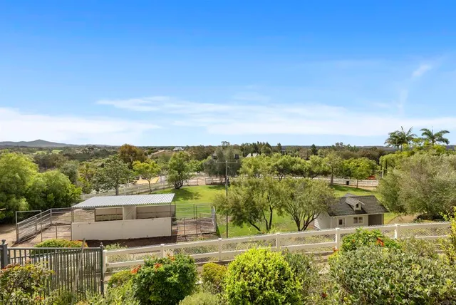 a view of residential houses with outdoor space and ocean view