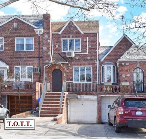 a front view of a house with parking area