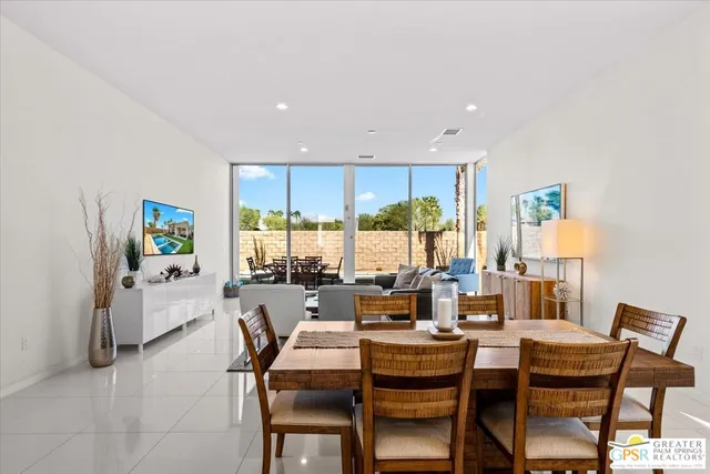 a living room with fireplace furniture and a large window