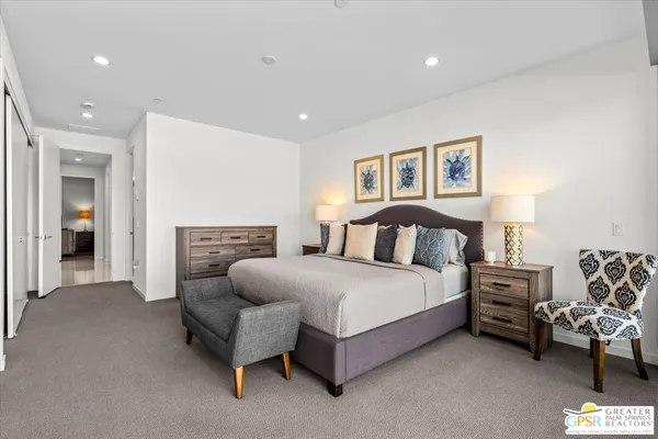 a spacious bedroom with a bed and a couch