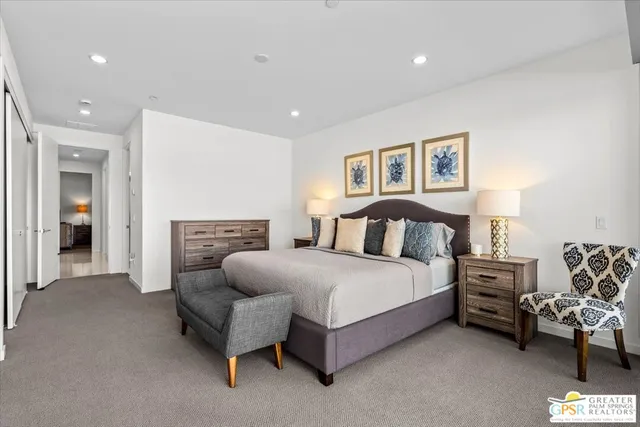 a spacious bedroom with a bed and a couch