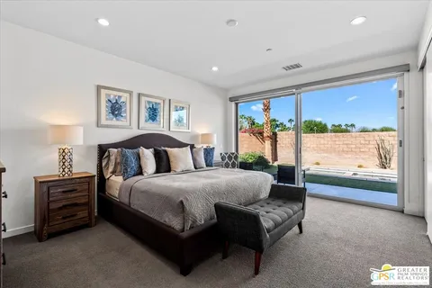 a spacious bedroom with a bed and a couch