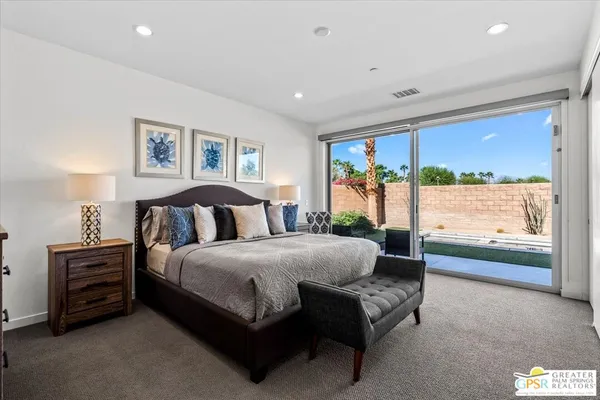 a spacious bedroom with a bed and a couch
