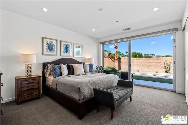 a spacious bedroom with a bed and a couch