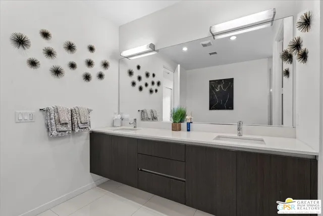 a bathroom with a double vanity sink mirror and double