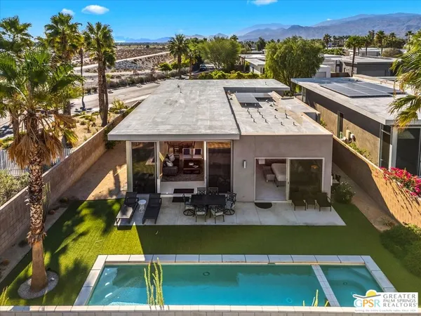 an aerial view of a house with swimming pool garden and patio