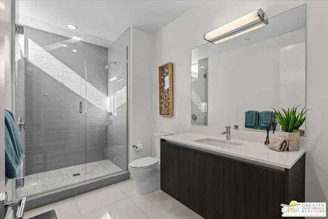 a bathroom with a double vanity sink toilet and shower