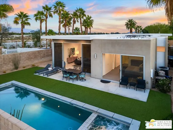 a view of a patio with table and chairs potted plants with swimming pool
