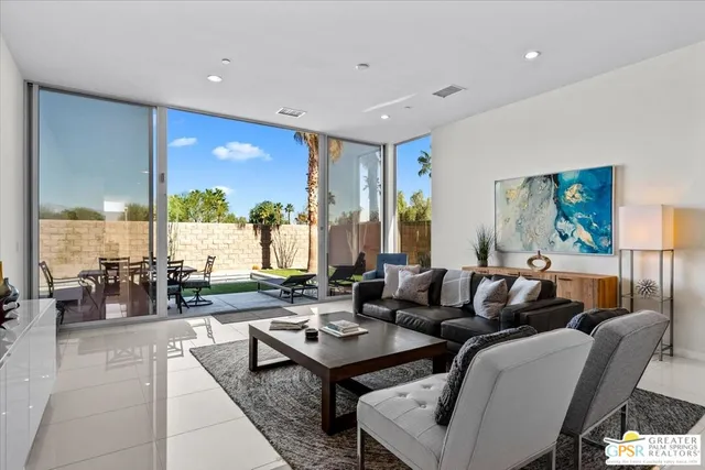 a living room with furniture and large windows