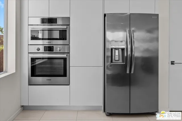 a kitchen with cabinets and stainless steel appliances