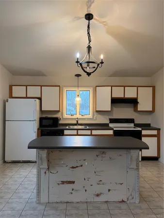 a kitchen with a counter space a sink and appliances