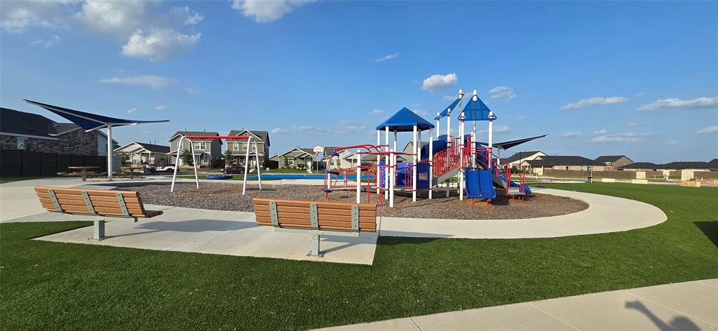 545 Sormonne Loop Kyle, TX 78640 - Photo 37 of 39 An expansive community playground features multi-level play structures and paved walking paths.