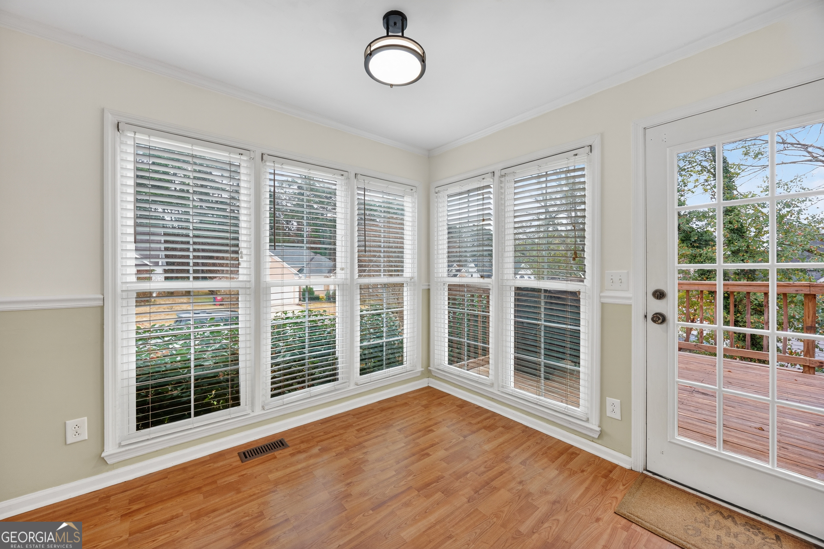 199 Springfield Boulevard Macon, GA 31210 - Photo 20 of 44 a view of an empty room with wooden floor and windows