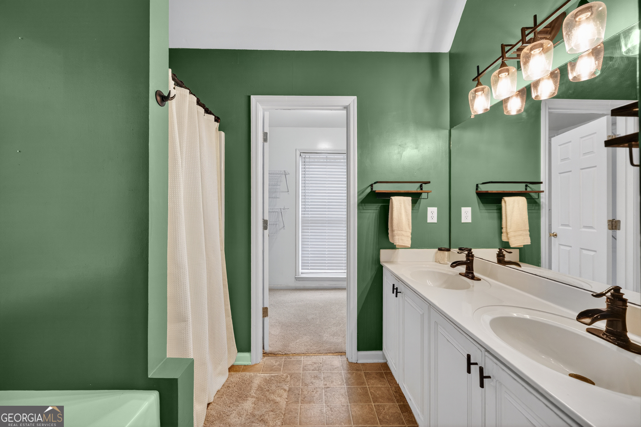 199 Springfield Boulevard Macon, GA 31210 - Photo 28 of 44 a bathroom with a double vanity sink and a mirror