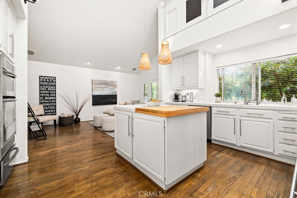 1 Centaurus, Unit 12 Irvine, CA 92603 - Photo 13 of 37 a kitchen with sink cabinets and wooden floor