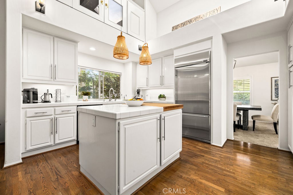 1 Centaurus, Unit 12 Irvine, CA 92603 - Photo 14 of 37 a kitchen with white cabinets and white appliances