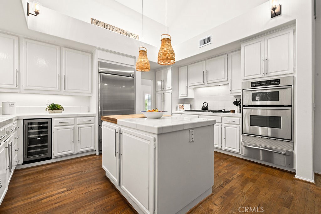 1 Centaurus, Unit 12 Irvine, CA 92603 - Photo 15 of 37 a kitchen with a refrigerator stove and white cabinets