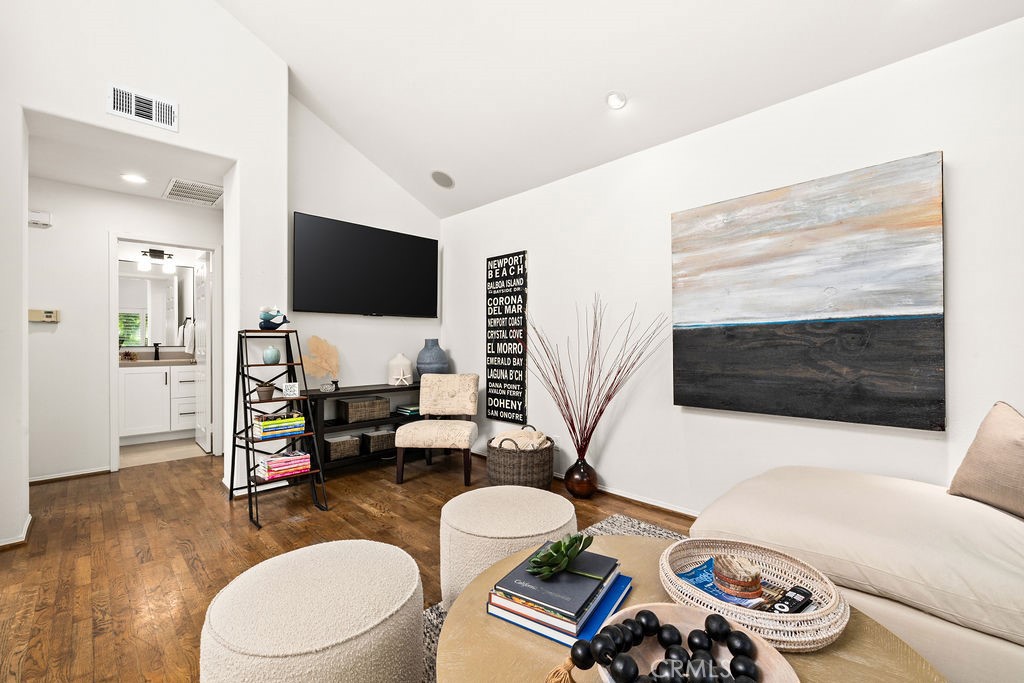 1 Centaurus, Unit 12 Irvine, CA 92603 - Photo 18 of 37 a living room with furniture a flat screen tv and a view of kitchen