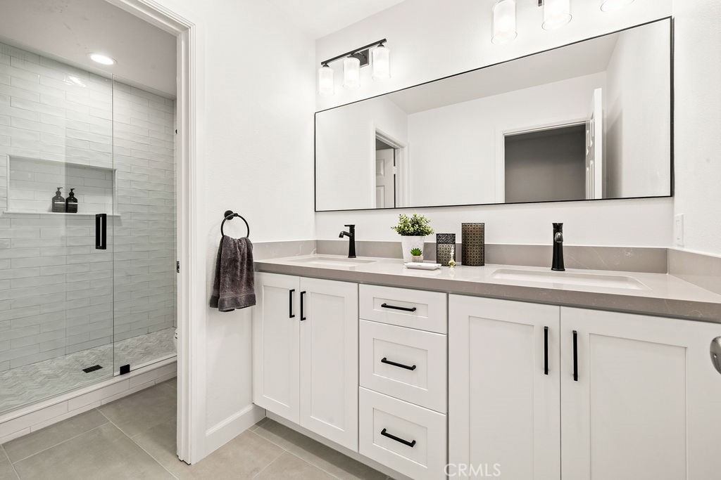 1 Centaurus, Unit 12 Irvine, CA 92603 - Photo 28 of 37 a bathroom with a shower sink and mirror