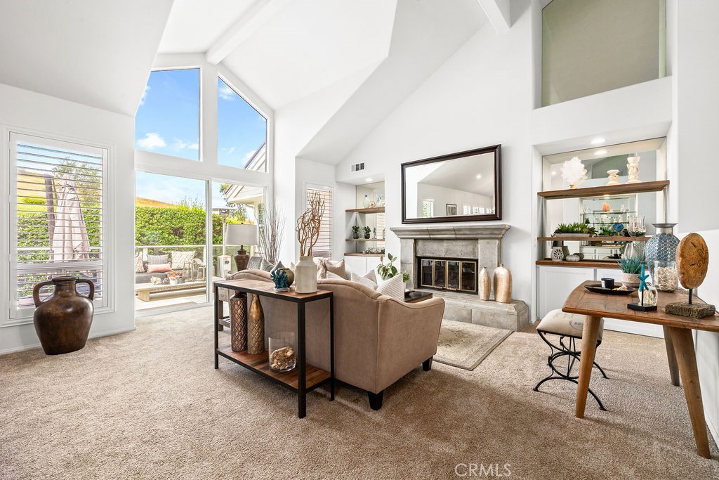 1 Centaurus, Unit 12 Irvine, CA 92603 - Photo 7 of 37 a living room with furniture a fireplace and large windows