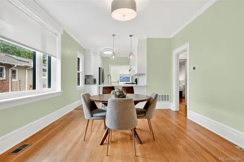 a view of a dining room with furniture and wooden floor