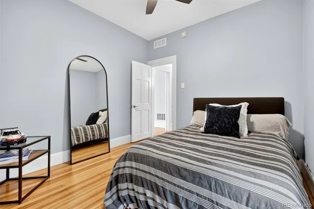 a bedroom with a bed and a potted plant