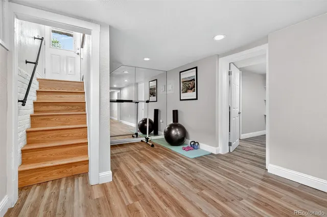a view of a room with wooden floor and stairs