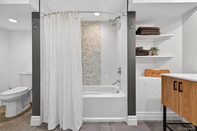 a bathroom with a shower curtain and a sink