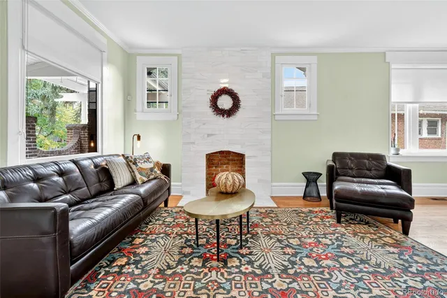 a living room with furniture a rug and a fireplace