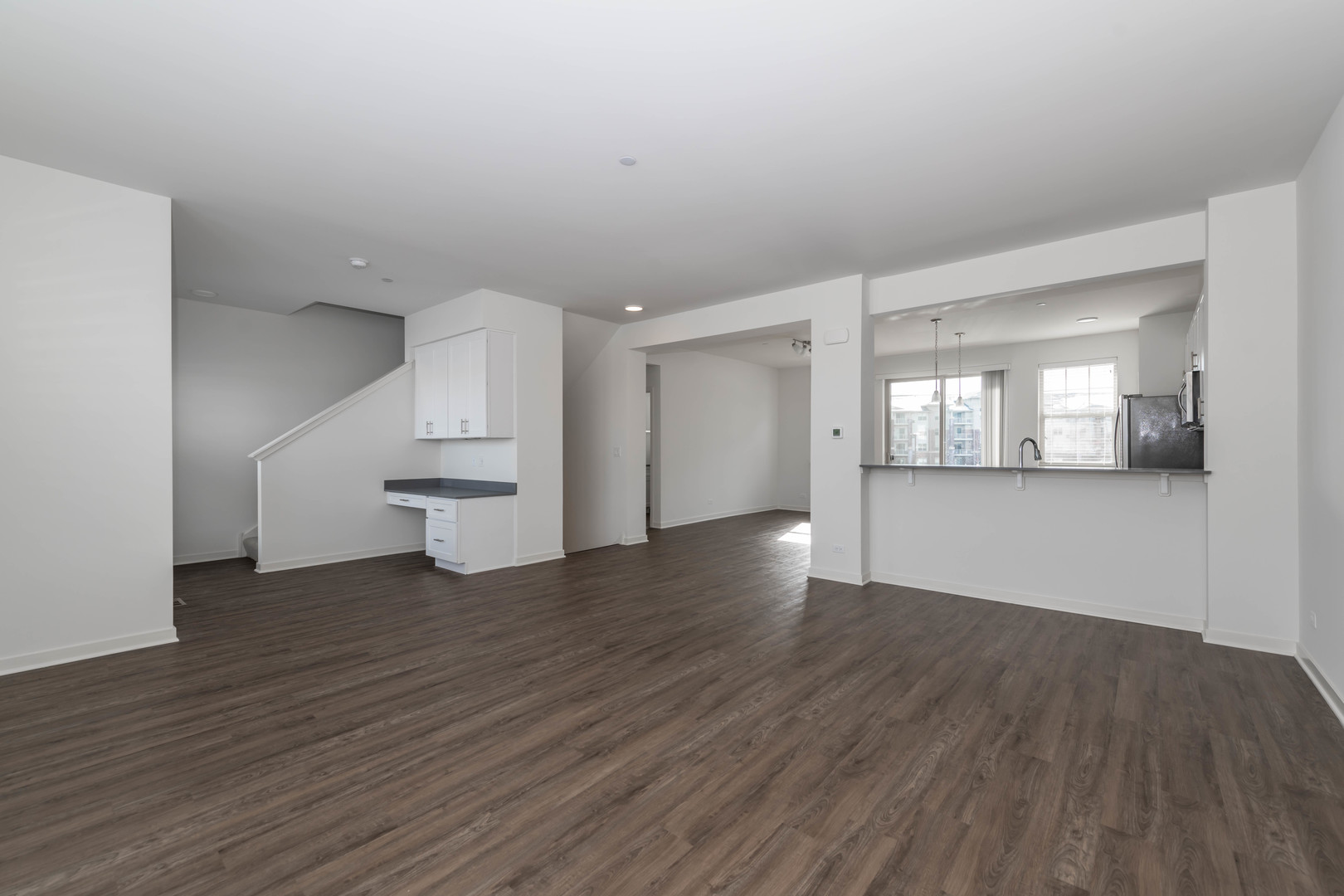 21599 West Field Court, Unit 21567 Deer Park, IL 60010 - Photo 2 of 14 an empty room with wooden floor and windows