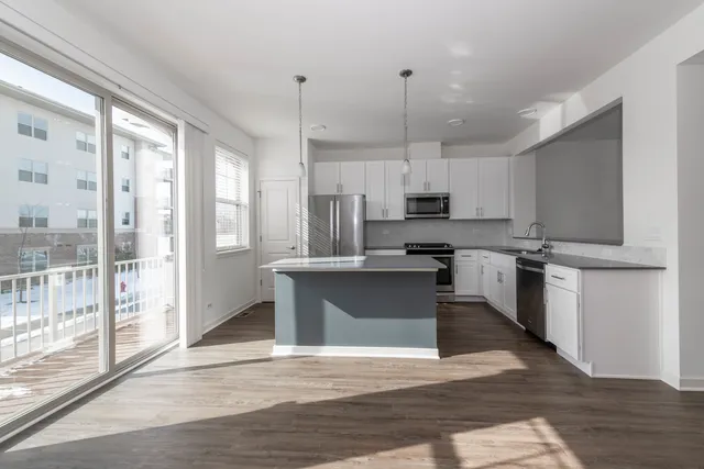 a large kitchen with cabinets and wooden floor