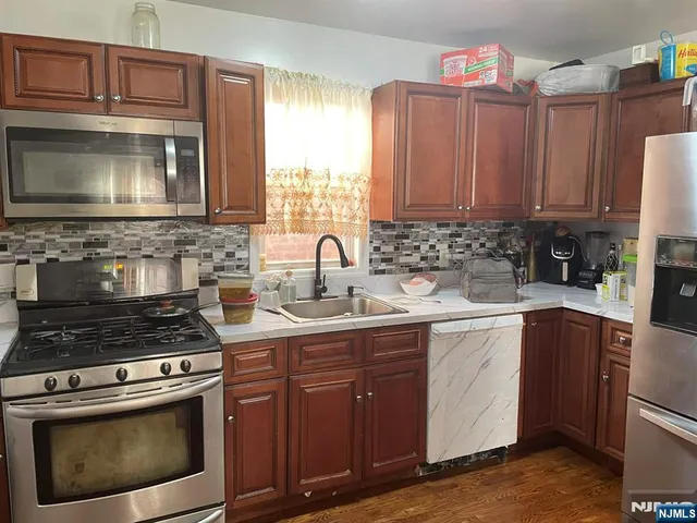 a kitchen with a stove microwave and sink
