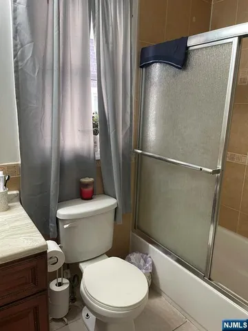 a white toilet sitting next to a shower