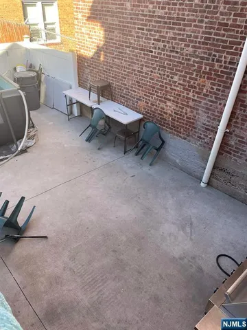 a view of a patio with table and chairs
