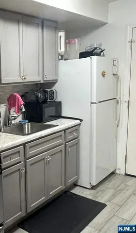 a white refrigerator freezer sitting in a kitchen