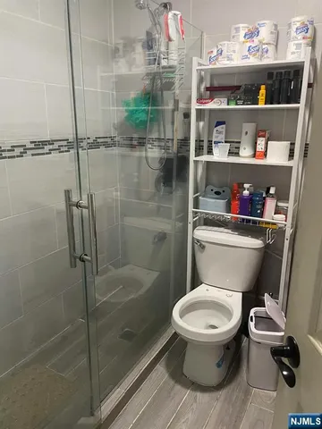 a bathroom with a toilet and a shower