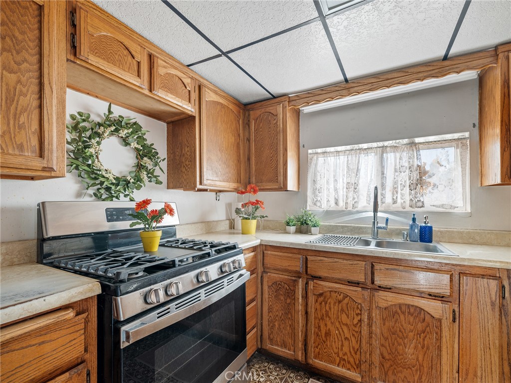 17757 Wheeler Road Helendale, CA 92342 - Photo 13 of 30 a kitchen with a stove a sink and a window