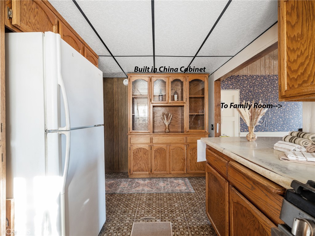 17757 Wheeler Road Helendale, CA 92342 - Photo 14 of 30 a kitchen with stainless steel appliances granite countertop a refrigerator a oven and white cabinets