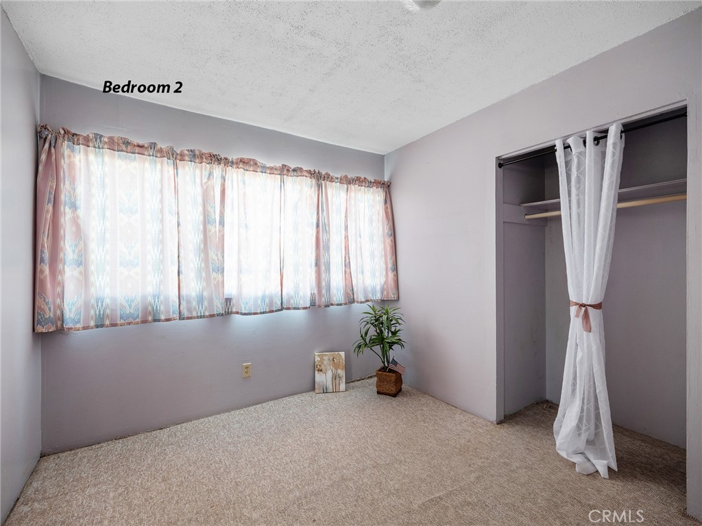 17757 Wheeler Road Helendale, CA 92342 - Photo 9 of 30 a room with a window and a ceiling fan