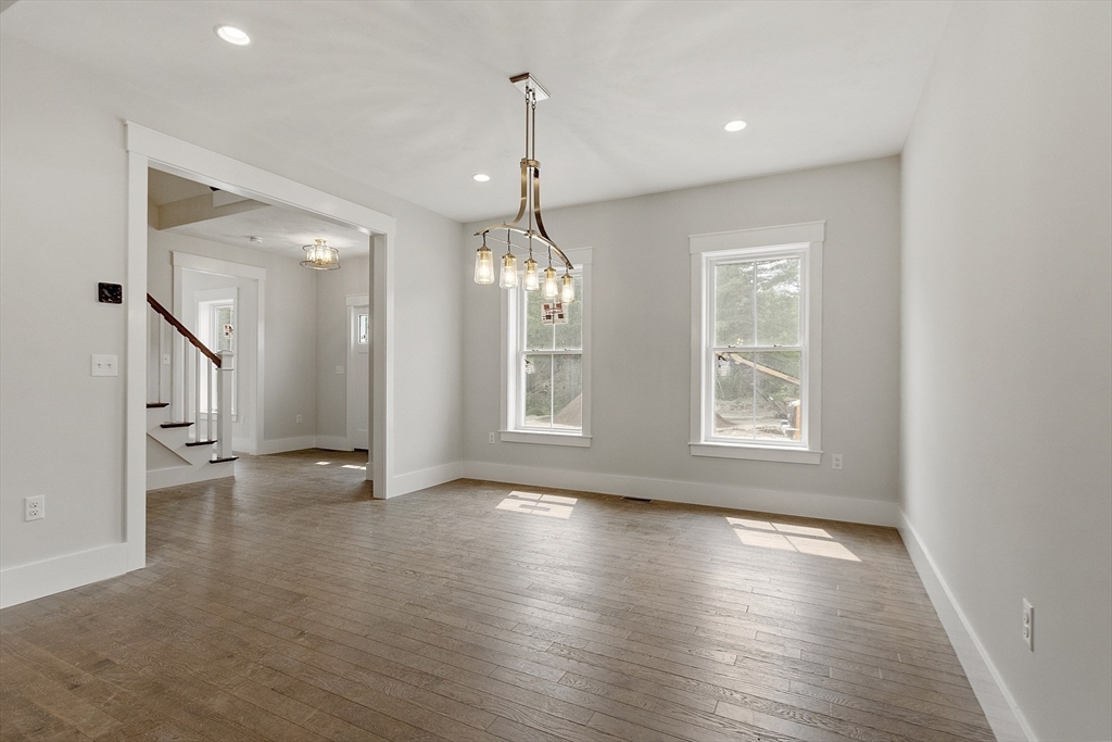 22 Waites Crossing Norfolk, MA 02056 - Photo 11 of 33 a view of an empty room with wooden floor and a window