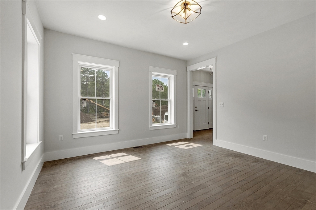 22 Waites Crossing Norfolk, MA 02056 - Photo 12 of 33 an empty room with wooden floor and windows