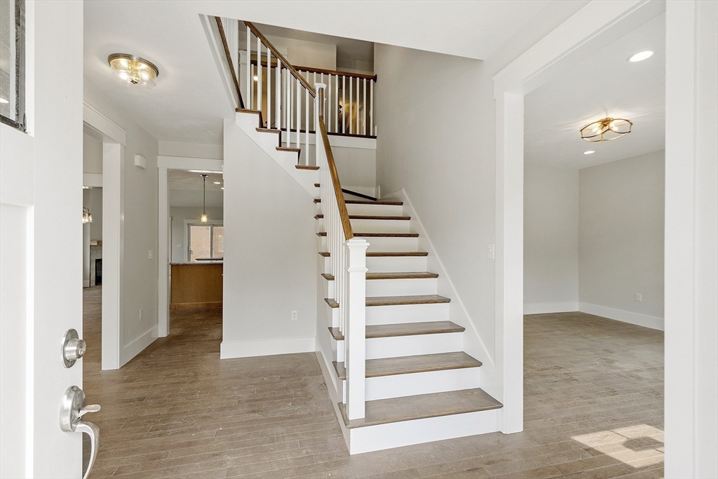 22 Waites Crossing Norfolk, MA 02056 - Photo 13 of 33 a view of entryway with wooden floor and stairs