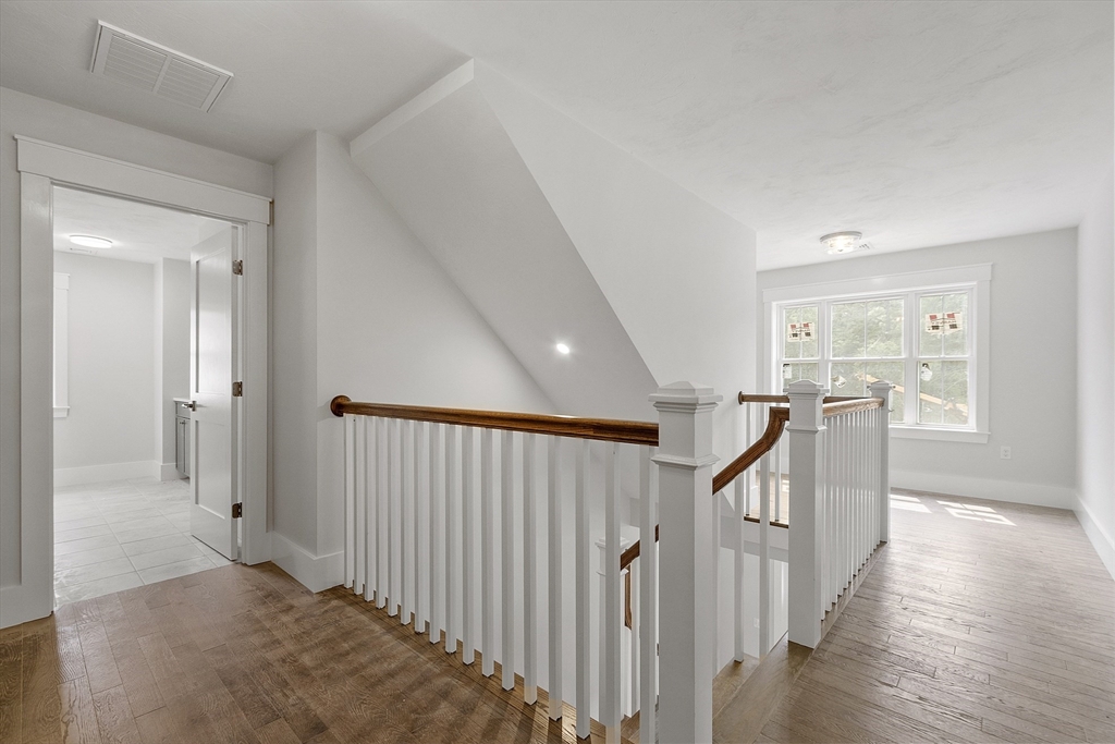 22 Waites Crossing Norfolk, MA 02056 - Photo 14 of 33 a view of a hallway with the wooden floor and stairs