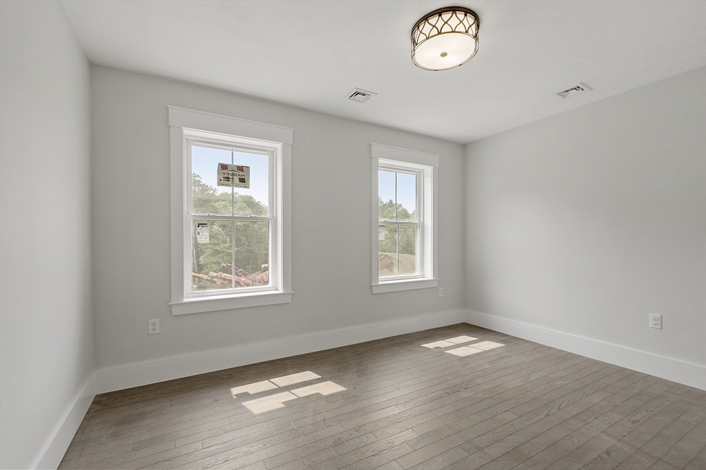 22 Waites Crossing Norfolk, MA 02056 - Photo 15 of 33 a view of an empty room with a window and wooden floor