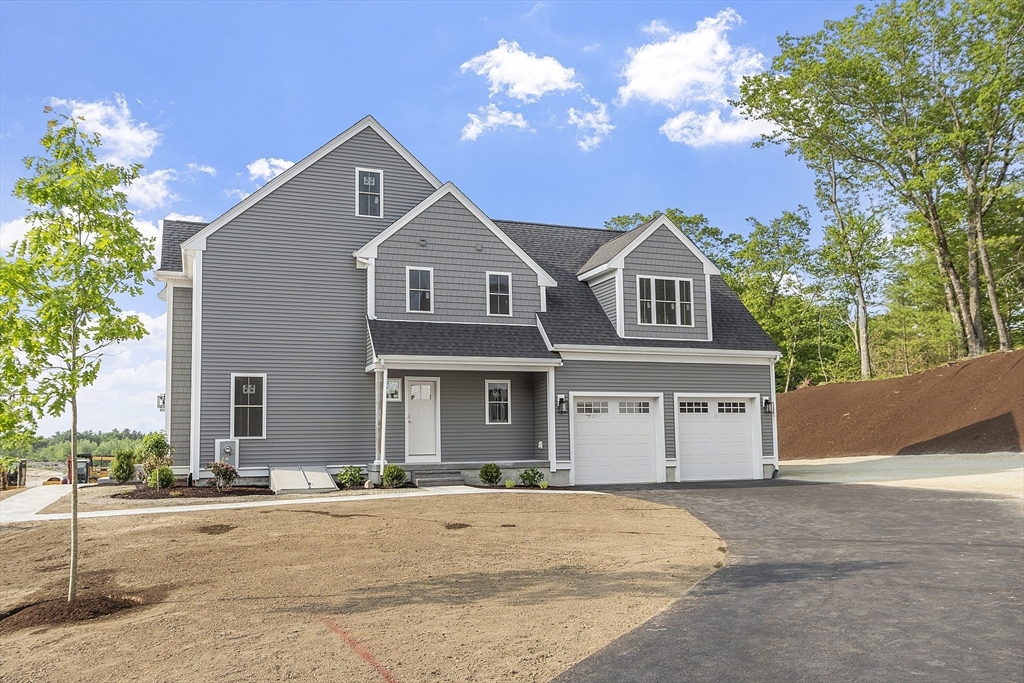 22 Waites Crossing Norfolk, MA 02056 - Photo 2 of 33 a front view of a house with a yard and garage