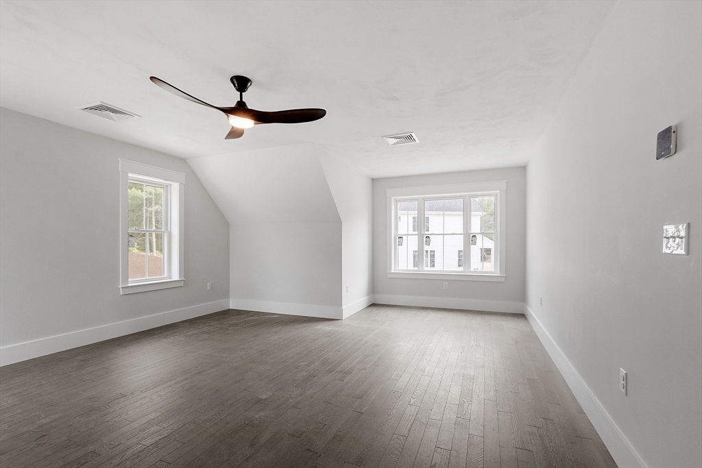 22 Waites Crossing Norfolk, MA 02056 - Photo 21 of 33 a view of an empty room with wooden floor and a window