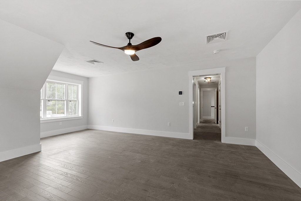 22 Waites Crossing Norfolk, MA 02056 - Photo 22 of 33 wooden floor in an empty room with a window