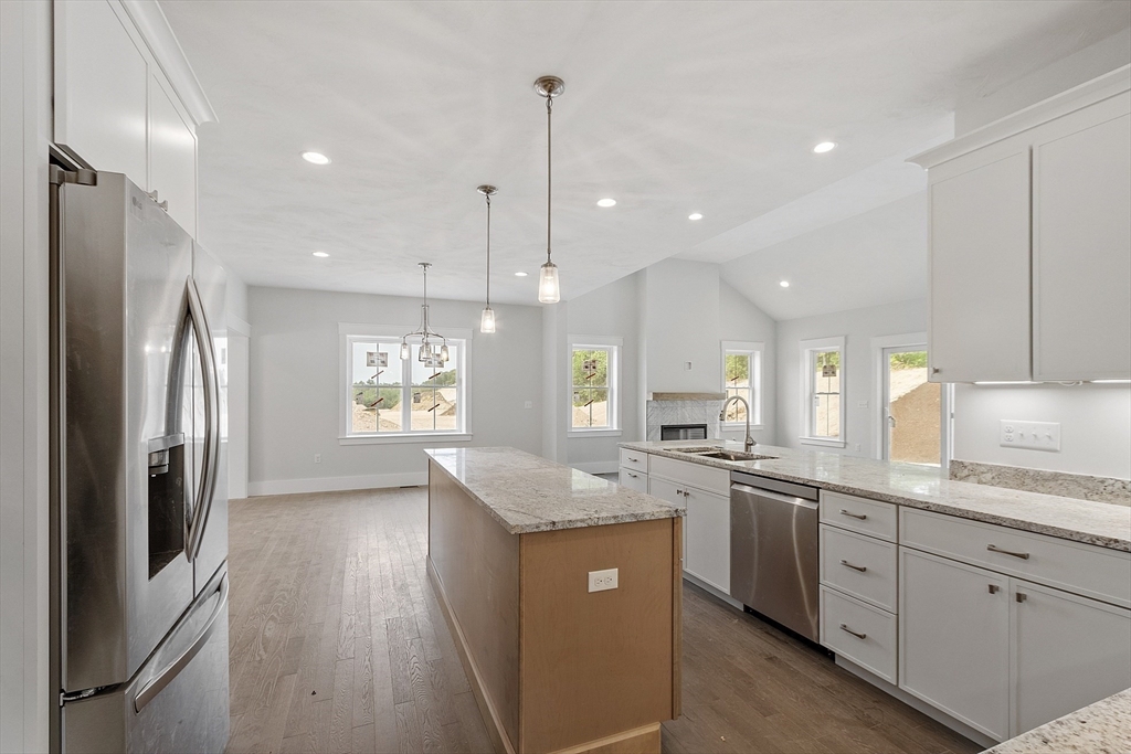 22 Waites Crossing Norfolk, MA 02056 - Photo 6 of 33 a kitchen with stainless steel appliances granite countertop a sink a stove a refrigerator and island with wooden floor