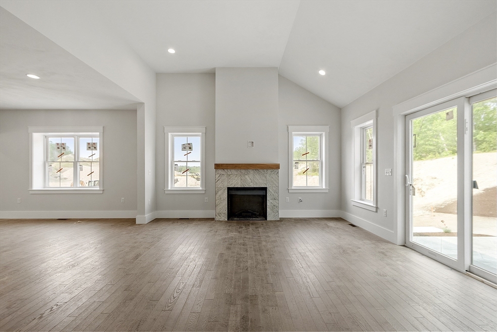 22 Waites Crossing Norfolk, MA 02056 - Photo 9 of 33 an empty room with wooden floor fireplace and windows